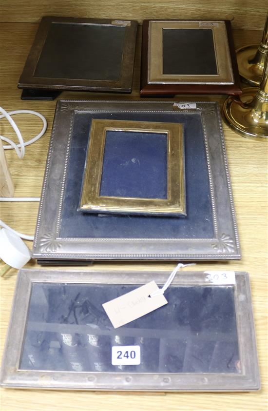 A silver photograph frame and four others